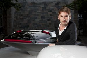 Designer Ora-Ïto seated beside a concept car, Milan 2011