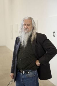 Artist Olivier Mosset standing in a white gallery, Milan 2009