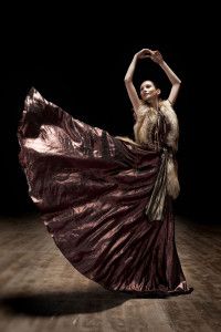 Dancer in a flowing bronze gown on a theatre stage, Sur la Terre inTown, 2011