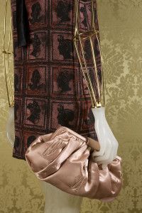 Satin clutch and printed dress on a mannequin, Miu Miu look book 2008