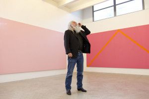 Artist Olivier Mosset in front of a large pink painting, Milan 2009