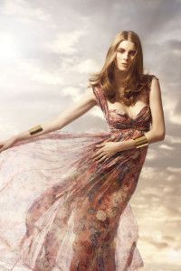 Model in a floral chiffon gown against a cloudy sky, Sur la Terre inTown 2012