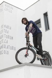 Vittorio Brumotti balancing his bike on a wall ledge, for Lotto Sport