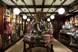 Ralph Lauren store interior with clothes on wooden tables, Milan