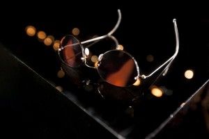 Sunglasses on a dark background with bokeh lights, Madame Figaro 2013