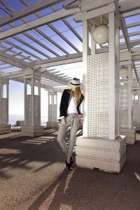 Model in black jacket under a seafront pergola, Nice, Germano Zama catalogue S/S 2012