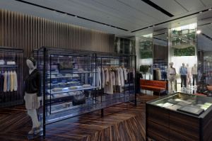 Prada Sport store with glass cabinets and dark wood floor, Corso Venezia, Milan