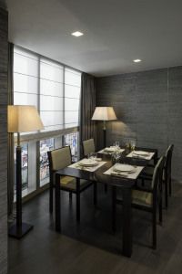 Dining room with dark table and floor lamp, Armani/Casa residence, Century Spire, Manila