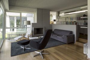 Living room with fireplace and lounge chair, country house in Casale Monferrato, Italy