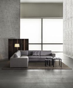 Armani/Casa living room with grey sofa and concrete walls, advertising campaign 2014