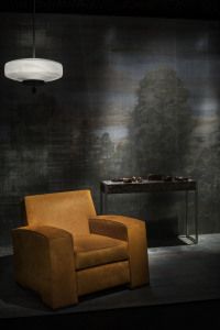 Armani/Casa leather armchair before a painted landscape wall, Salone del Mobile 2014
