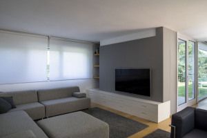 Living room with sofa and television wall, country house in Casale Monferrato, Italy
