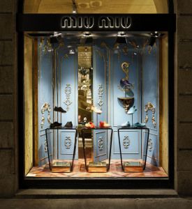 Miu Miu shop window with shoes on pedestals and pale blue panels, via Sant'Andrea, Milan