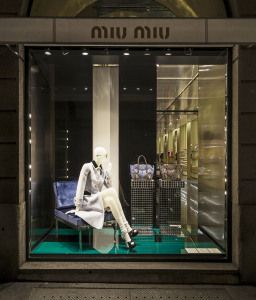 Miu Miu shop window with mannequin on a blue armchair, via della Spiga, Milan