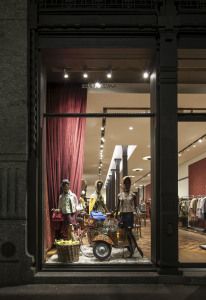 Dolce & Gabbana shop window with mannequins and red curtains, Milan