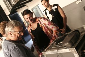 Crew reviewing takes at the monitor, backstage