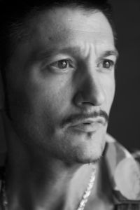 Black and white portrait of a man on set, backstage