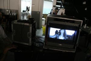 Video village with monitors on set, backstage