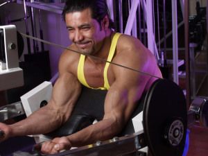 Bodybuilder training on a cable machine