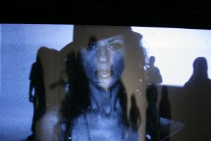 Singer on a video monitor, backstage of a music video shoot
