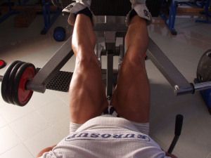 Legs on a leg press machine, point of view shot
