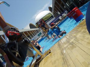 Spinning bikes beside a swimming pool at a fitness expo