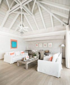 Living room under a white pitched timber ceiling, Villa Flamands, Cheval Blanc St-Barth