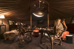 Cigar lounge in the evening with antler chairs, Cheval Blanc Courchevel