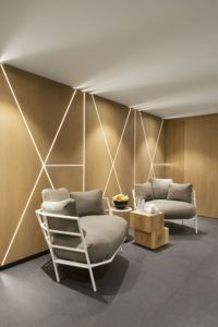 Relaxation area with armchairs and light lines on wood panels, White 1921 hotel, Courchevel