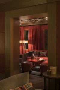 Private salon of the bar with red curtains, Cheval Blanc Courchevel
