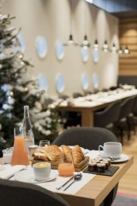 Breakfast table with croissants and porthole windows, White 1921 hotel, Courchevel