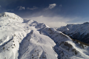 Snow-covered peaks in the Alps, aerial drone view