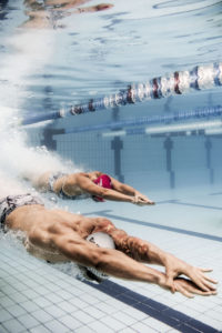 Two swimmers underwater in a pool lane, arena Water Instinct S/S 2018 catalogue
