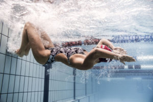 Swimmer in printed suit tumbling underwater, arena Water Instinct S/S 2018 catalogue