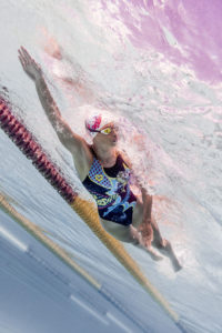 Female swimmer in a printed swimsuit diving along the lane rope, arena Water Instinct S/S 2018 catalogue
