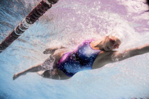 Swimmer in a galaxy-print swimsuit underwater, arena Water Instinct S/S 2018 catalogue